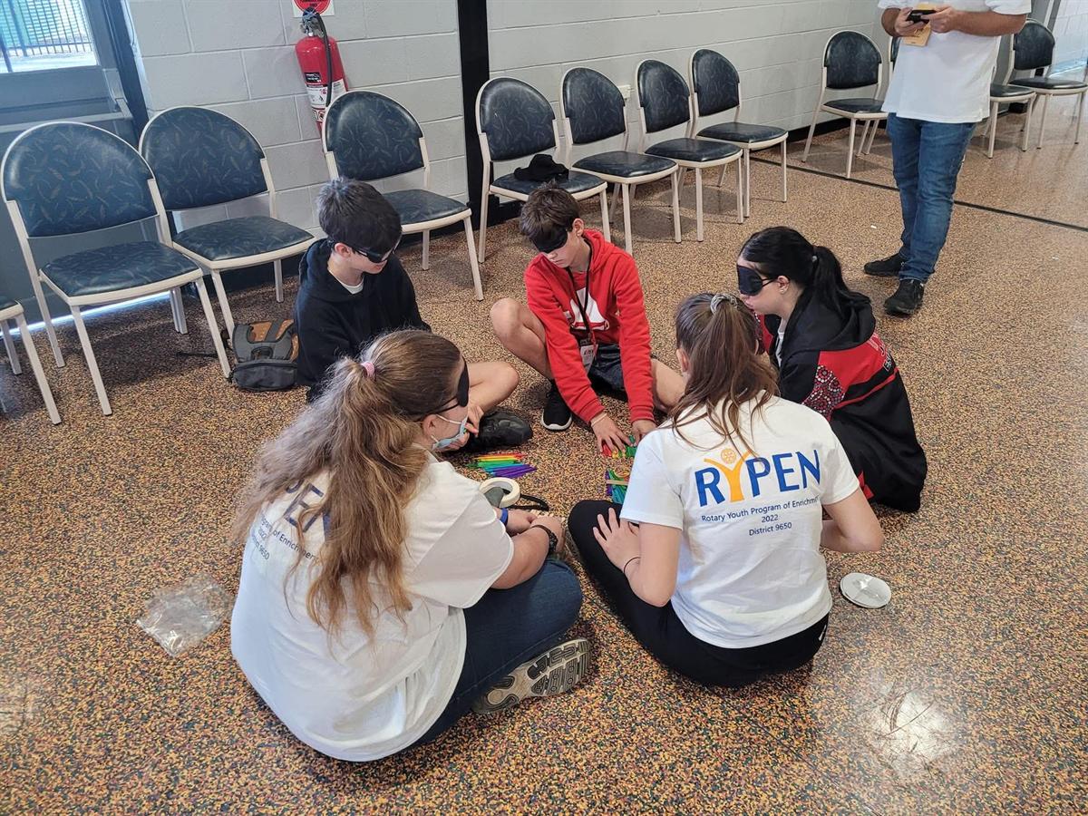 A blindfolded group activity at the 2022 camp
