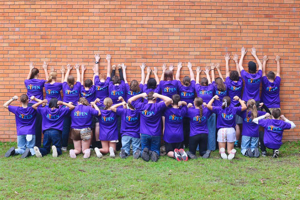 Participants and leaders celebrating at the end of a camp