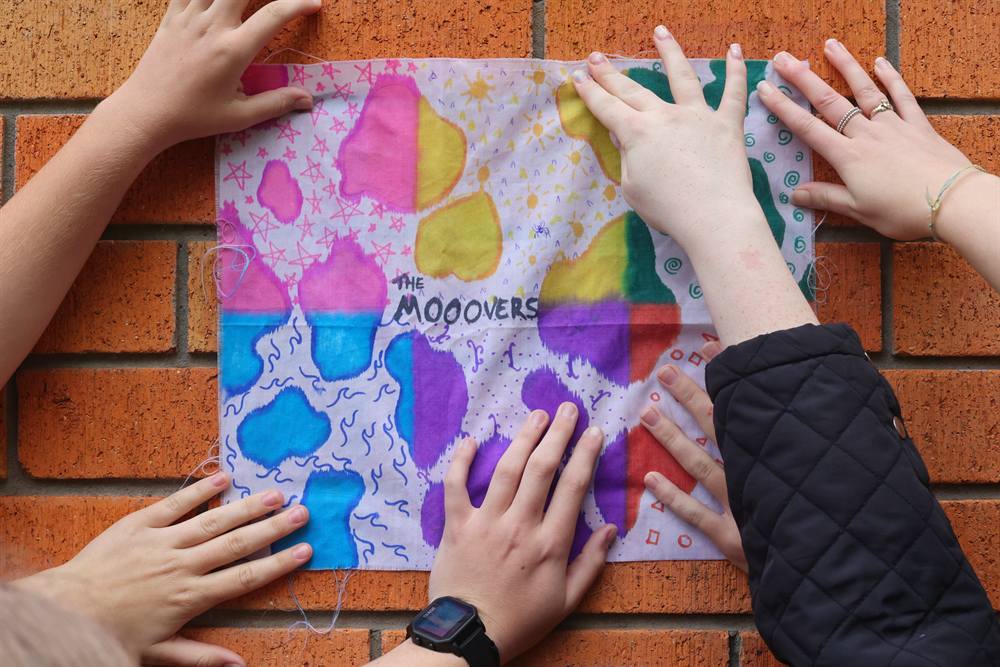 Participants working together on a collaborative artwork