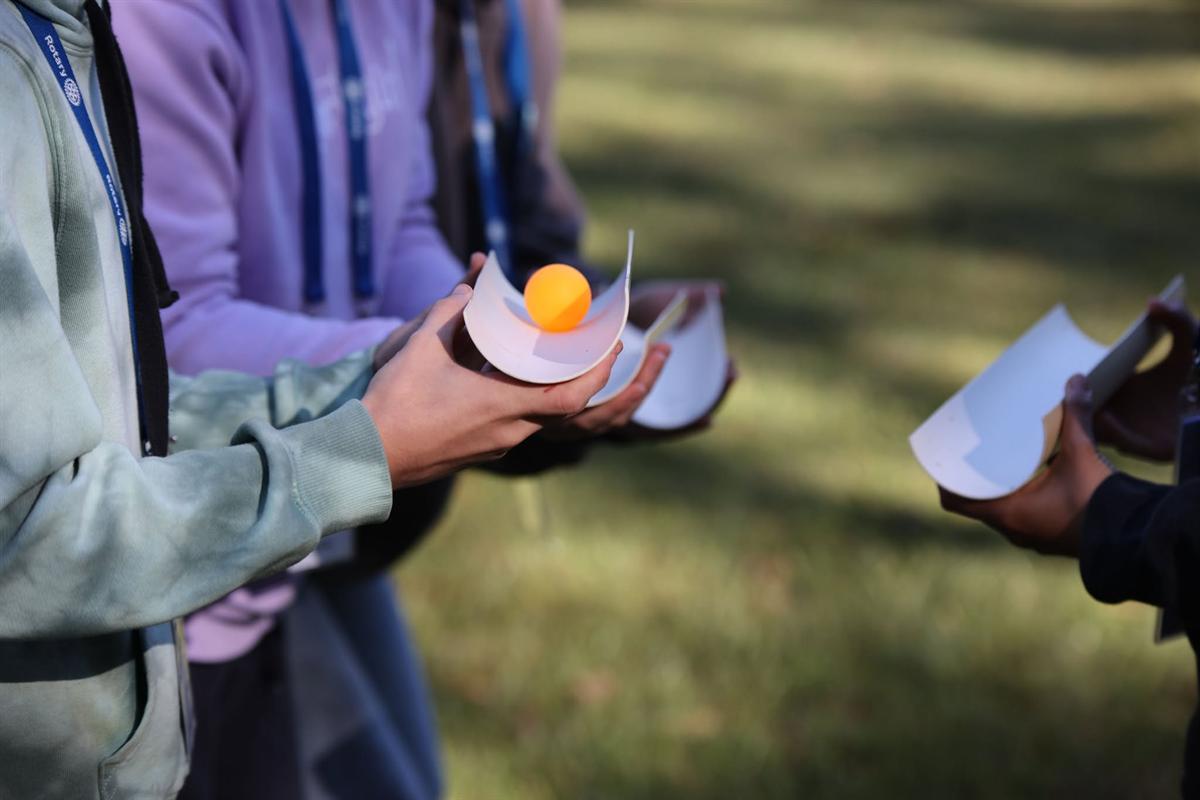 Close up of a ball being passed between paper cups
