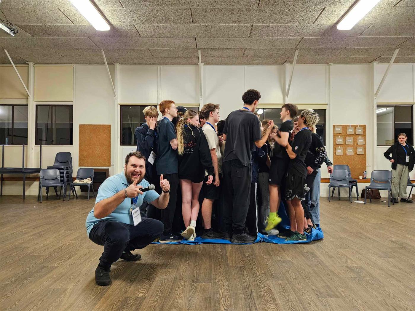 A team balancing together on a single mat