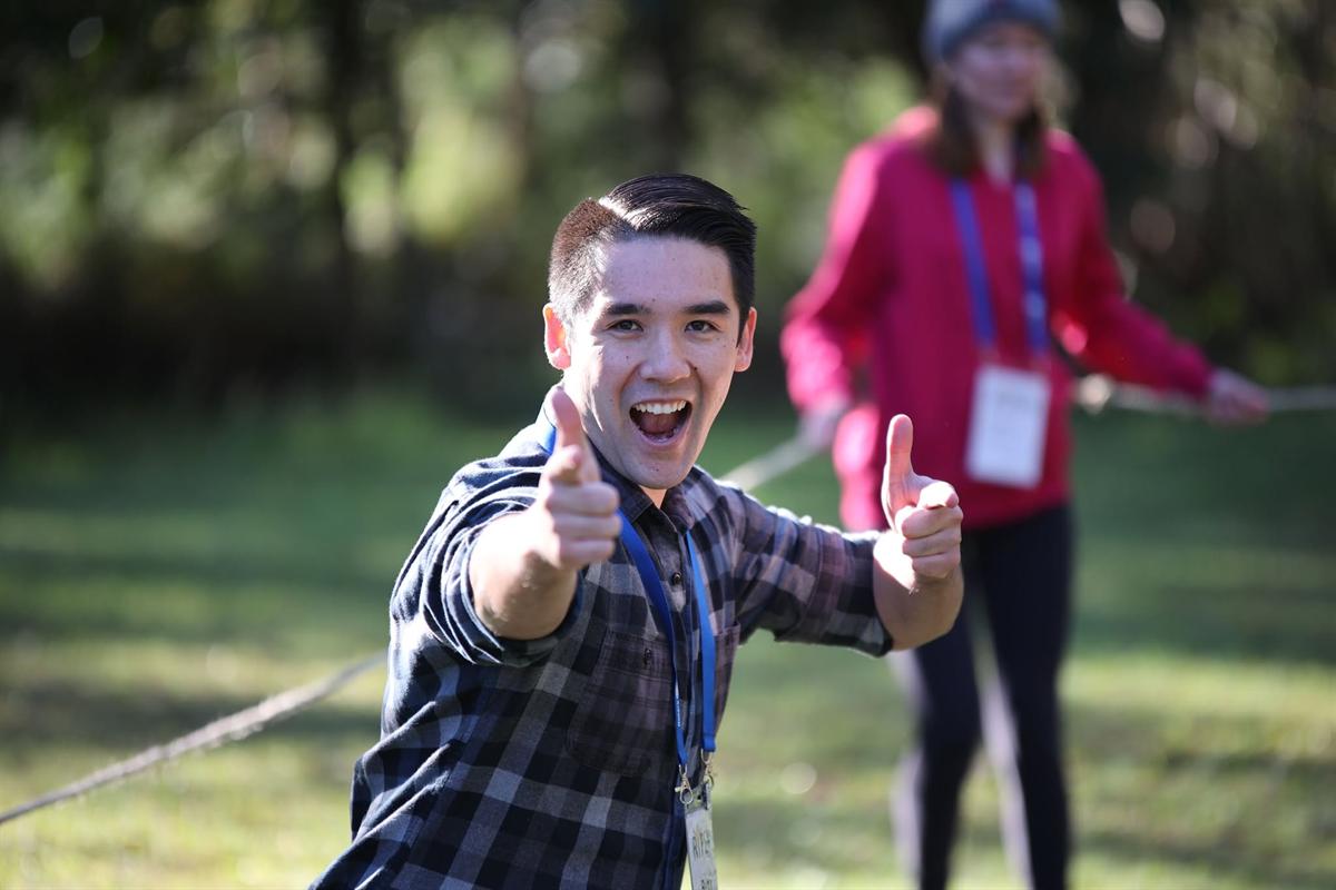 A leader cheering on a team mid-activity