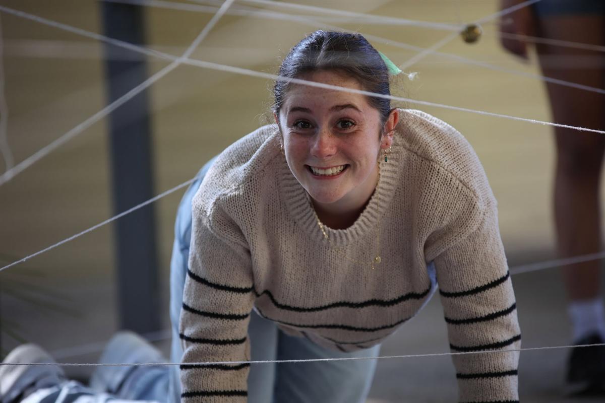 A participant grinning her way through a string web challenge