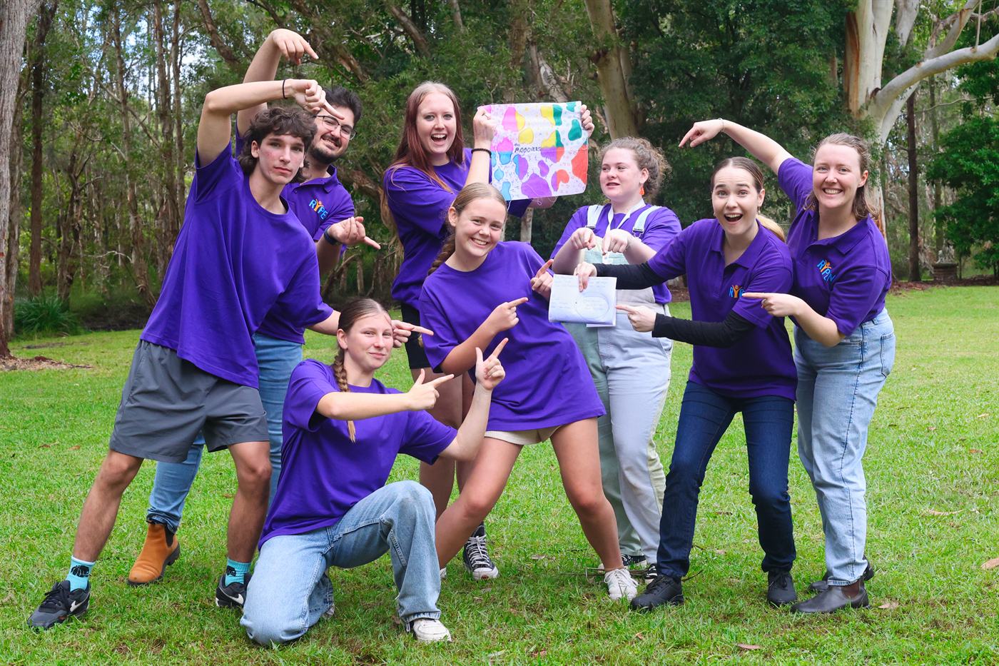 A group celebrating the artwork their team made